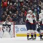 Washington Capitals players celebrate their goal against Columbus Blue Jackets&#39; Elvis Merzlikins during the second period of an NHL hockey game on Thursday, Jan. 5, 2023, in Columbus, Ohio. (AP Photo/Jay LaPrete)