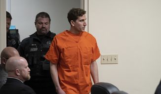 Bryan Kohberger, right, who is accused of killing four University of Idaho students in November 2022, is escorted into a courtroom for a hearing in Latah County District Court, Thursday, Jan. 5, 2023, in Moscow, Idaho. (AP Photo/Ted S. Warren, Pool)