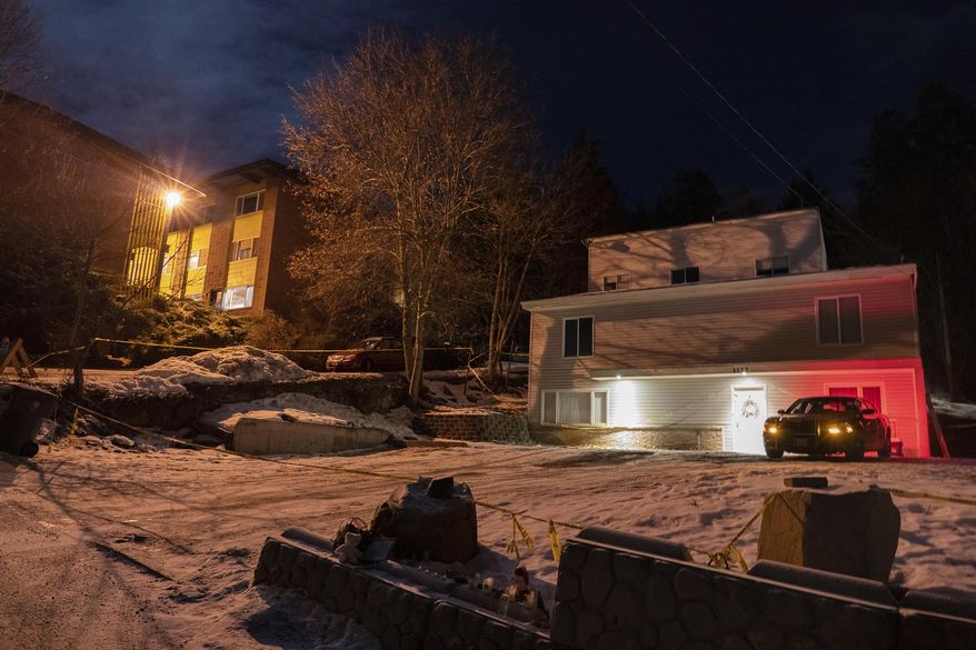 A private security officer sits in a vehicle, Tuesday, Jan. 3, 2023, in front of the house in Moscow, Idaho where four University of Idaho students were killed in November, 2022. (AP Photo/Ted S. Warren)