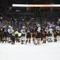FILE - Members of the St. Louis Blues and Anaheim Ducks gather on the ice as Blues defenseman Jay Bouwmeester, who suffered a medical emergency, is worked on by medical personnel during the first period of an NHL hockey game on Feb. 11, 2020, in Anaheim, Calif. The horror that swept across the NFL when Buffalo BIlls defensive back Damar Hamlin collapsed and went into cardiac arrest during a game this week in Cincinnati was all too familiar to members of the hockey community. (AP Photo/Mark J. Terrill, File)