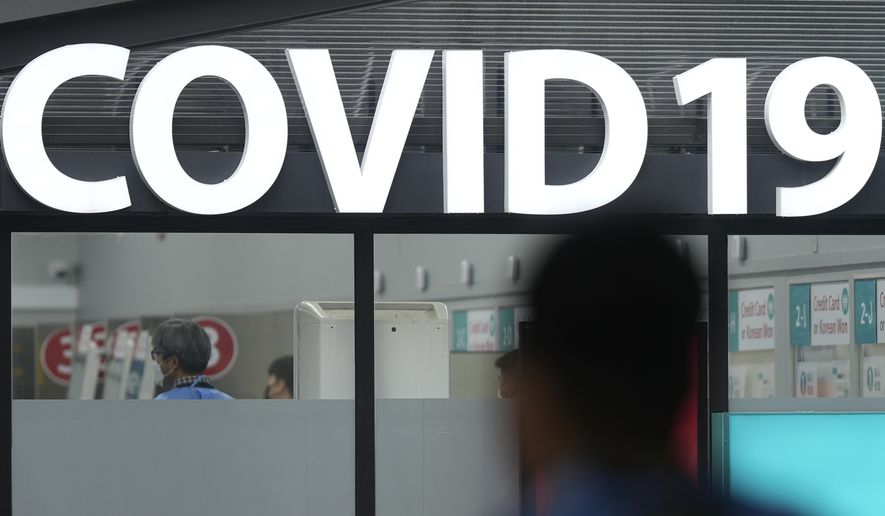 A health worker walks outside of a COVID-19 testing center at the Incheon International Airport In Incheon, South Korea, Thursday, Jan. 5, 2023. (AP Photo/Lee Jin-man)