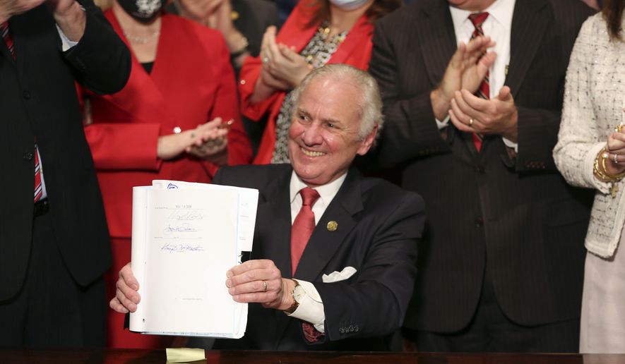 South Carolina Gov. Henry McMaster holds up a bill banning almost all abortions in the state after he signed it into law on Feb. 18, 2021, in Columbia, S.C. The South Carolina ban on abortions after cardiac activity is no more after the latest legal challenge to the state&#x27;s 2021 law proved successful. The state Supreme Court ruled Thursday, Jan. 5, 2023, that the restrictions violate the state constitution&#x27;s right to privacy. (AP Photo/Jeffrey Collins, File)