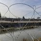 Razor wire is strung along the U.S.-Mexico border in El Paso, Texas, on Tuesday, Dec. 20, 2022. (AP Photo/Giovanna Dell&#x27;Orto)