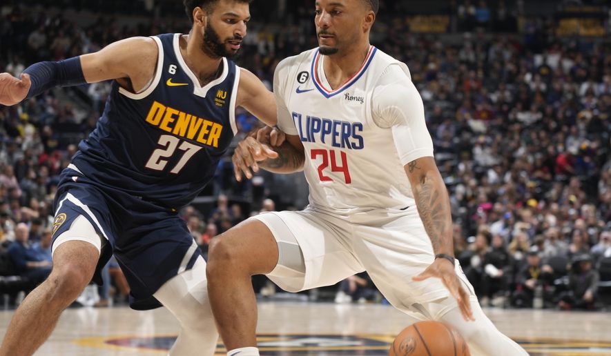 Los Angeles Clippers forward Norman Powell, right, drives as Denver Nuggets guard Jamal Murray defends during the second half of an NBA basketball game Thursday, Jan. 5, 2023, in Denver. (AP Photo/David Zalubowski)