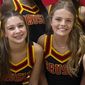 In this image provided by Janae Montgomery, Caroline Gill, left, and Maggie Dunn are shown in their cheerleading uniforms at Brusly High School in Brusly, Louisiana. Gill and Dunn were killed Saturday, Dec. 31, 2022, in a car crash. Authorities said a police officer from nearby Addis, La., crashed into the car the two girls were in after he joined a pursuit of a suspect that began in Baton Rouge. (Janae Montgomery via AP)