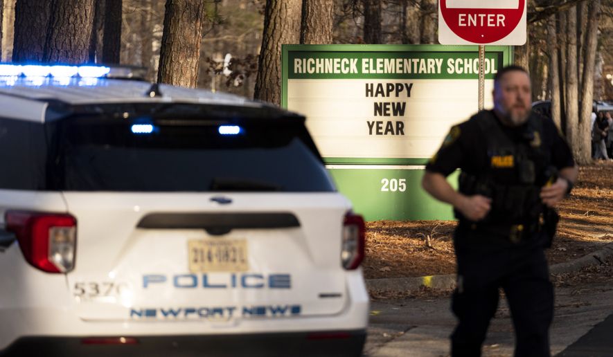 Police respond to a shooting at Richneck Elementary School, Friday, Jan. 6, 2023, in Newport News, Va. A shooting at a Virginia elementary school sent a teacher to the hospital and ended with “an individual” in custody Friday, police and school officials in the city of Newport News said. (Billy Schuerman/The Virginian-Pilot via AP) ** FILE **