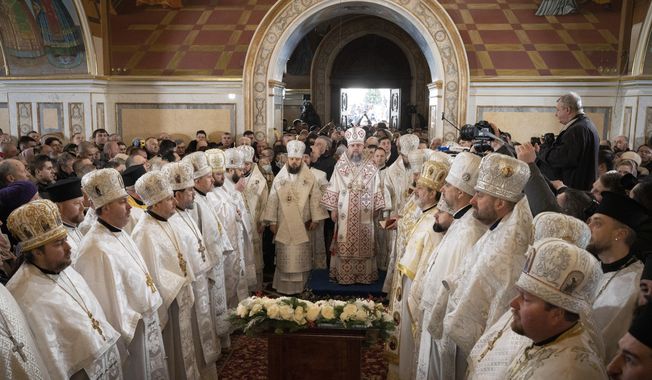 Metropolitan Epiphanius, center right, and priests deliver an Orthodox Christmas service inside the nearly 1,000-year-old Pechersk Lavra Cathedral of Kyiv, Ukraine, Saturday, Jan. 7, 2023. Hundreds of Ukrainians heard the Orthodox Christmas service in the Ukrainian language for the first time at Kyiv’s 1,000-year-old Lavra Cathedral on Orthodox Christmas Day, a demonstration of independence from the Russian orthodox church. (AP Photo/Roman Hrytsyna)