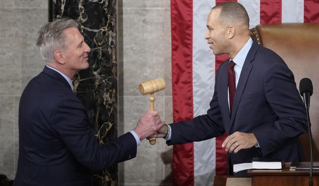 Incoming House Speaker Kevin McCarthy of Calif., receives the gavel from House Minority Leader Hakeem Jeffries of N.Y., on the House floor at the U.S. Capitol in Washington, early Saturday, Jan. 7, 2023. (AP Photo/Andrew Harnik)