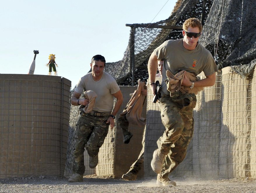 In this Nov. 3, 2012, file photo, Britain&#x27;s Prince Harry, right, or just plain Capt. Wales as he is known in the British Army, races out from the VHR (very high readiness) tent to scramble his Apache with fellow pilots, during his 12-hour shift at the British-controlled flight-line in Camp Bastion southern Afghanistan. (AP Photo/John Stillwell, Pool, File)