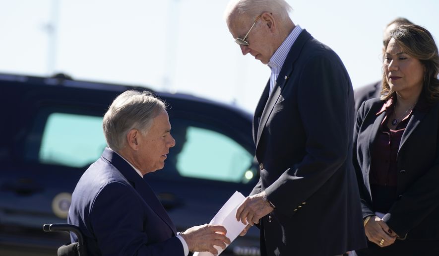 Texas Gov. Greg Abbott hands President Joe Biden a letter that outlined laws that the governor said would make a great difference, if enforced, in addressing the &quot;chaos&quot; at the border, as Biden arrives at El Paso International Airport in El Paso Texas, Sunday, Jan. 8, 2023. Rep. Veronica Escobar, D-Texas, stands at right. (AP Photo/Andrew Harnik)