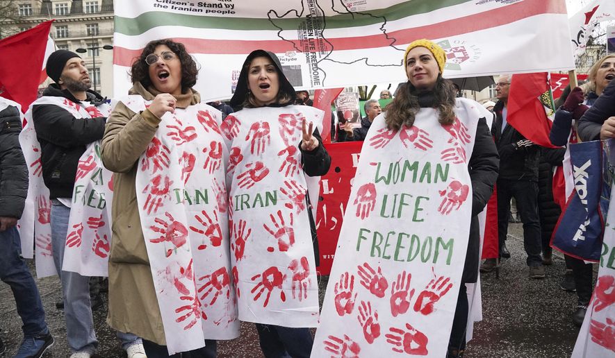 Protesters gather at Marble Arch before they march to Trafalgar Square to protest against the Islamic Republic in Iran following the death of Mahsa Amini, in London, Sunday, Jan. 8, 2023. (Jonathan Brady/PA via AP)