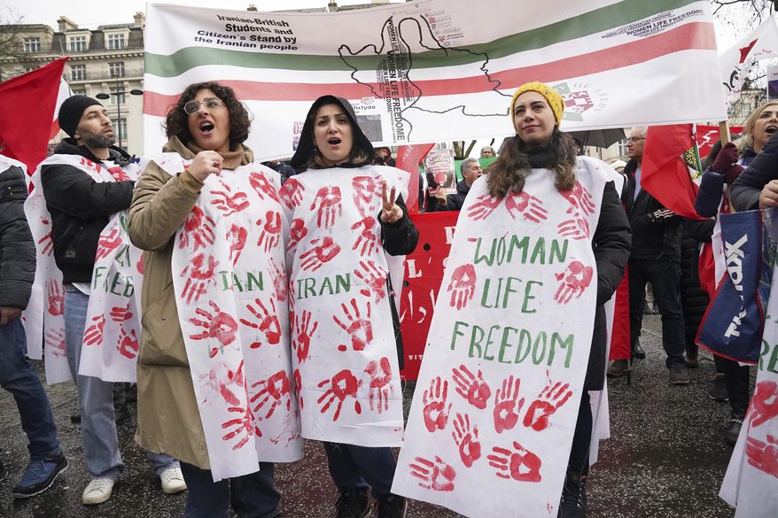 Protesters gather at Marble Arch before they march to Trafalgar Square to protest against the Islamic Republic in Iran following the death of Mahsa Amini, in London, Sunday, Jan. 8, 2023. (Jonathan Brady/PA via AP)