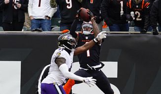 Cincinnati Bengals wide receiver Ja&#39;Marr Chase (1) makes a catch over Baltimore Ravens cornerback Daryl Worley (41) for a touchdown in the first half of an NFL football game in Cincinnati, Sunday, Jan. 8, 2023. (AP Photo/Jeff Dean)
