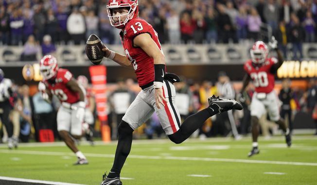 Georgia quarterback Stetson Bennett (13) runs into the end zone for a touchdown against TCU during the first half of the national championship NCAA College Football Playoff game, Monday, Jan. 9, 2023, in Inglewood, Calif. (AP Photo/Ashley Landis)