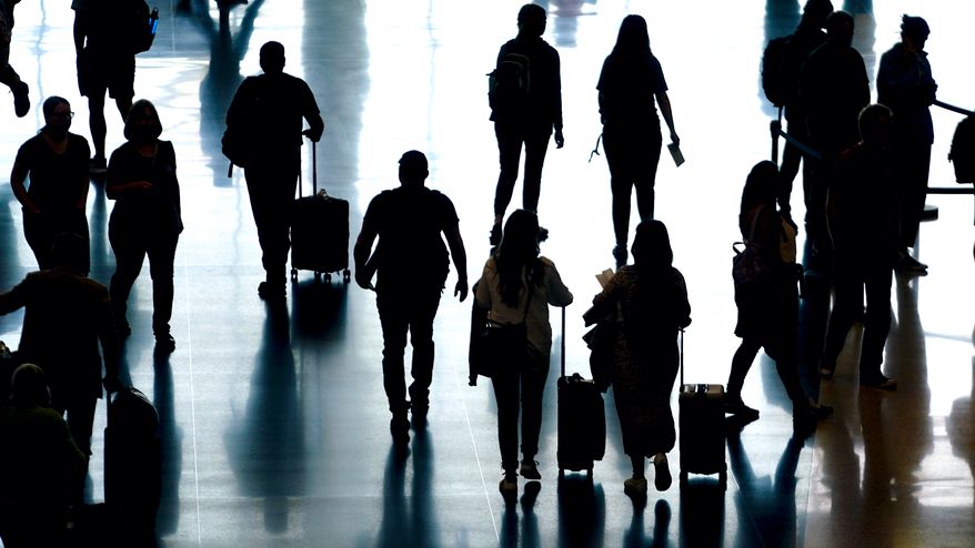 People pass through Salt Lake City International Airport Monday, June 27, 2022, in Salt Lake City. (AP Photo/Rick Bowmer)