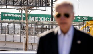 A large &quot;Welcome to Mexico&quot; sign hung over the Bridge of the Americas is visible as President Joe Biden talks with U.S. Customs and Border Protection officers as he tours the El Paso port of entry, a busy port of entry along the U.S.-Mexico border, in El Paso Texas, Sunday, Jan. 8, 2023. (AP Photo/Andrew Harnik)