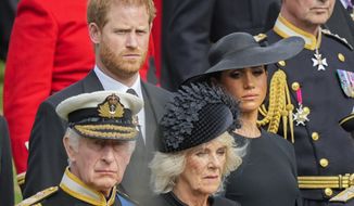 Britain&#39;s King Charles III, from bottom left, Camilla, the Queen Consort, Meghan, Duchess of Sussex and Prince Harry watch as the coffin of Queen Elizabeth II is placed into the hearse following the state funeral service in Westminster Abbey in central London Monday, Sept. 19, 2022. Prince Harry has defended his memoir that lays bare rifts inside Britain&#39;s royal family. He says in TV interviews broadcast Sunday that he wanted to &quot;own my story&quot; after 38 years of &quot;spin and distortion&quot; by others. (AP Photo/Martin Meissner, Pool, File)