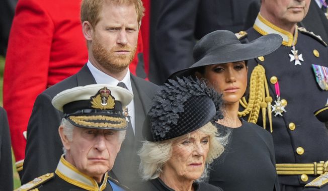 Britain&#x27;s King Charles III, from bottom left, Camilla, the Queen Consort, Meghan, Duchess of Sussex and Prince Harry watch as the coffin of Queen Elizabeth II is placed into the hearse following the state funeral service in Westminster Abbey in central London Monday, Sept. 19, 2022. Prince Harry has defended his memoir that lays bare rifts inside Britain&#x27;s royal family. He says in TV interviews broadcast Sunday that he wanted to &quot;own my story&quot; after 38 years of &quot;spin and distortion&quot; by others. (AP Photo/Martin Meissner, Pool, File)