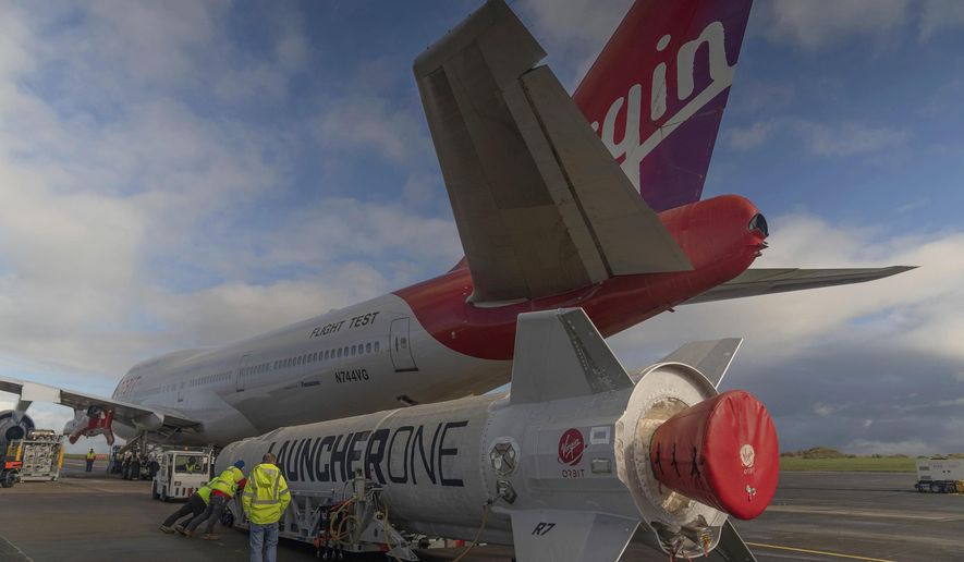 In this undated photo provided by Virgin Orbit on Monday, Jan. 9, 2023, Virgin Atlantic Cosmic Girl, a repurposed Virgin Atlantic Boeing 747 aircraft that will carry a rocket, is parked at Spaceport Cornwall, at Cornwall Airport in Newquay, England. Engineers are making final preparations for the first satellite launch from the U.K. later Monday, when a repurposed passenger plane is expected to release a Virgin Orbit rocket carrying several small satellites into space. (Virgin Orbit via AP)