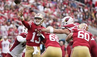 San Francisco 49ers quarterback Brock Purdy (13) throws a touchdown pass during the first half of an NFL football game against the Arizona Cardinals in Santa Clara, Calif., Sunday, Jan. 8, 2023. (AP Photo/Godofredo A. Vásquez)