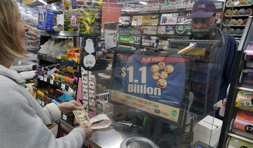 A Mega Millions customer purchases her tickets for the estimated jackpot of $1.1 Billion at the Fuel On Convenience Store in Pittsburgh, Monday, Jan. 9, 2023. (AP Photo/Gene J. Puskar)