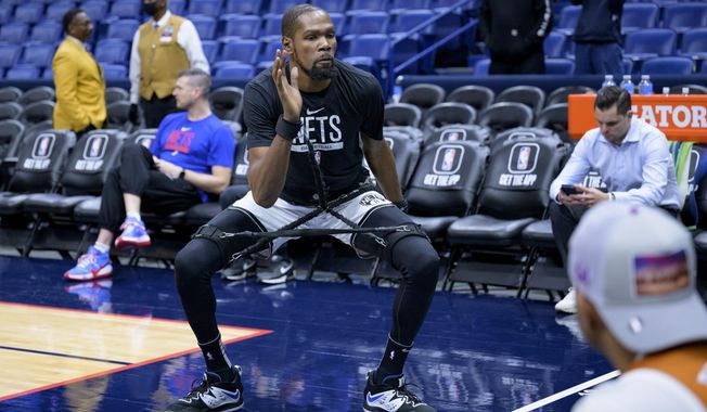 Brooklyn Nets forward Kevin Durant warms up before an NBA basketball game against the New Orleans Pelicans in New Orleans, Friday, Jan. 6, 2023. (AP Photo/Matthew Hinton)