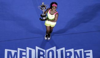 Serena Williams holds the trophy after defeating Maria Sharapova in the women&#x27;s singles final at the Australian Open tennis championship in Melbourne, Australia. The Australian Open will be the first Grand Slam tournament since Serena Williams walked away from tennis and played her farewell match in New York at the U.S. Open.(AP Photo/Lee Jin-man, File) **FILE**