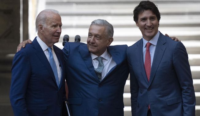 Mexican President Andres Manuel Lopez Obrador embraces, President Joe Biden and Canada Prime Minister Justin Trudeau following a joint news conference at the North American Leaders Summit, Tuesday, Jan. 10, 2023, in Mexico City. (Adrian Wyld/The Canadian Press via AP)