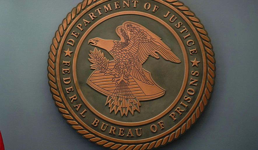The seal for the Federal Bureau of Prisons is seen at the Federal Bureau of Prisons headquarters in Washington, Oct. 24, 2022. (AP Photo/Carolyn Kaster, File)