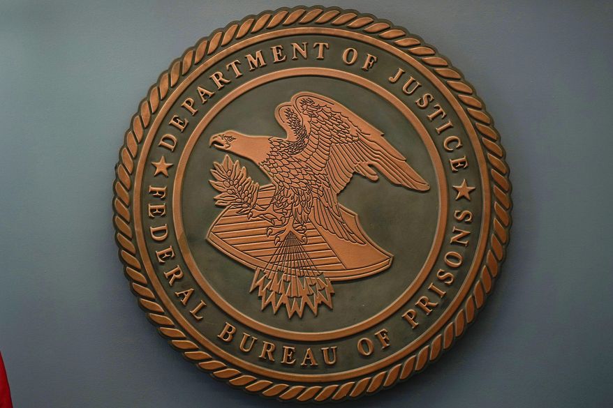 The seal for the Federal Bureau of Prisons is seen at the Federal Bureau of Prisons headquarters in Washington, Oct. 24, 2022. (AP Photo/Carolyn Kaster, File)