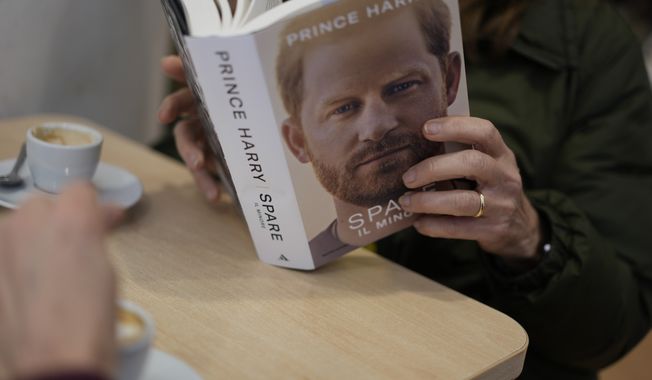 A customer reads a copy of the new book by Prince Harry called &quot;Spare&quot; at a book store in Rome, Tuesday, Jan. 10, 2023. Prince Harry&#x27;s memoir &quot;Spare&quot; arrives in bookstores on Tuesday, providing a varied portrait of the Duke of Sussex and the royal family. (AP Photo/Andrew Medichini)