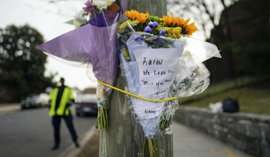 Flowers are secured to a pole as a memorial to Karon Blake, 13, on the corner of Quincy Street NE and Michigan Avenue NE in the Brookland neighborhood of Washington, Tuesday, Jan. 10, 2023. The note reads, &quot;Karon we will love and miss you dearly.&quot; Karon Blake was shot and killed on the 1000 block of Quincy Street NE early morning Saturday, Jan. 7, 2023. (AP Photo/Carolyn Kaster) **FILE**