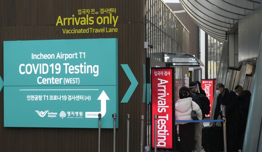 Passengers arriving from China enters a COVID-19 testing center at the Incheon International Airport in Incheon, South Korea, Tuesday, Jan. 10, 2023. China suspended visas Tuesday for South Koreans to come to the country for tourism or business in apparent retaliation for COVID-19 testing requirements on Chinese travelers. (AP Photo/Ahn Young-joon)