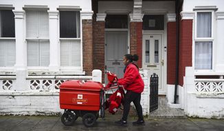 Royal Mail worker Leila delivers mail in Balham, London, Tuesday, Jan. 12, 2021. Britain’s postal service said it was hit Wednesday, Jan. 11, 2023 by a “cyber incident” that&#39;s temporarily preventing it from sending letters or parcels to other countries. (Kirsty O&#39;Connor/PA via AP, File)