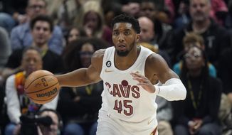 Cleveland Cavaliers guard Donovan Mitchell (45) brings the ball up during the first half of the team&#39;s NBA basketball game against the Utah Jazz on Tuesday, Jan. 10, 2023, in Salt Lake City. (AP Photo/Rick Bowmer)