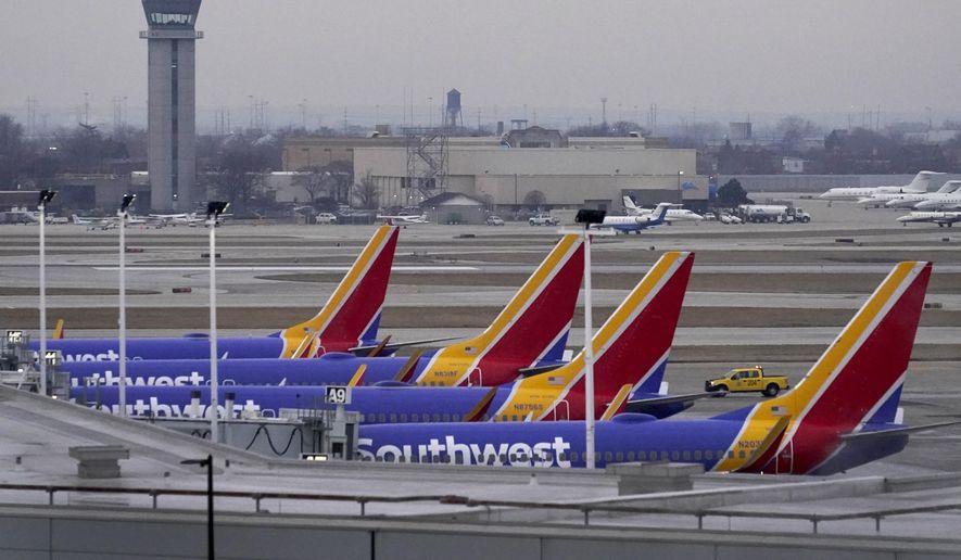 Four Southwest Airlines passenger jets sit at their gates at Chicago&#x27;s Midway Airport as flight delays stemming from a computer outage at the Federal Aviation Administration has brought departures to a standstill across the U.S. Wednesday, Jan. 11, 2023, in Chicago. (AP Photo/Charles Rex Arbogast)