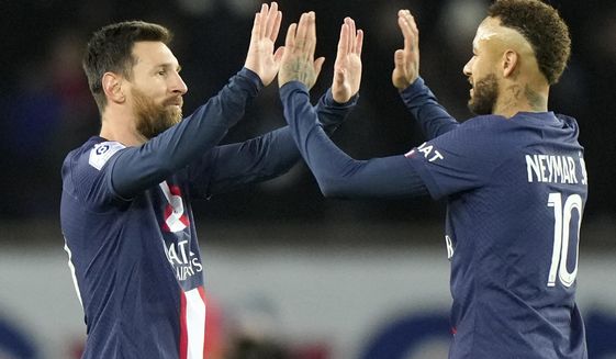 PSG&#x27;s Lionel Messi, left, celebrates with PSG&#x27;s Neymar after scoring his sides second goal during the French League One soccer match between Paris Saint-Germain and Angers at the Parc des Princes in Paris, France, Wednesday, Jan. 11, 2023. (AP Photo/Francois Mori)