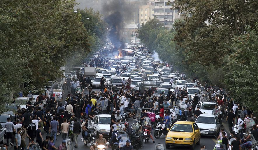 In this photo taken by an individual not employed by the Associated Press and obtained by the AP outside Iran, protesters chant slogans during a protest over the death of a woman who was detained by the morality police, in downtown Tehran, Iran on Sept. 21, 2022. The widespread resolve against Russia&#x27;s invasion of Ukraine demonstrates the power of a unified response against human rights abuses, a leading watchdog group said Thursday, Jan. 12, 2023, and comes amid growing dissatisfaction with autocratic regimes, with protests in Iran, China and elsewhere. (AP Photo, File )