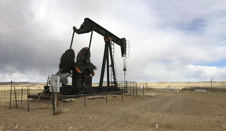 This Feb. 26, 2021, file photo shows an oil well east of Casper, Wyo. Booming oil and gas revenue has put Wyoming back among states with big budget surpluses but Republican Gov. Mark Gordon cautioned lawmakers Wednesday, Jan. 11, 2023, to save, not splurge, out of concern that tough times will eventually return. (AP Photo/Mead Gruver, File)