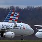 American Airlines planes sit stored at Pittsburgh International Airport on March 31, 2020, in Imperial, Pa. Federal officials said Wednesday Jan. 4, 2023, that American Airlines retaliated against flight attendants who complained about jet fuel fumes seeping into airplane cabins. (AP Photo/Gene J. Puskar, File)
