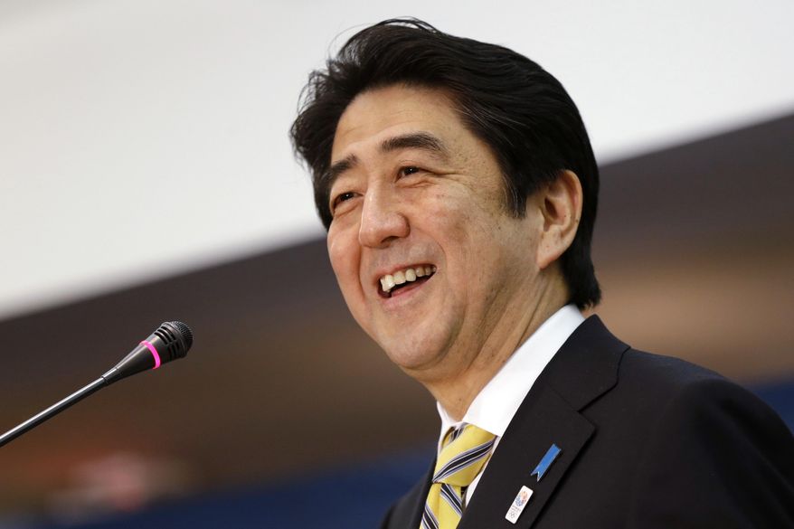 Japanese Prime Minister Shinzo Abe laughs while speaking at the Center for Strategic International Studies in Washington on Feb. 22, 2013. Tetsuya Yamagami, Abe's suspected assassin, is expected to face murder charges Friday, Jan. 13, 2023, in Japan's highest profile case in recent years. (AP Photo/Jacquelyn Martin, File)
