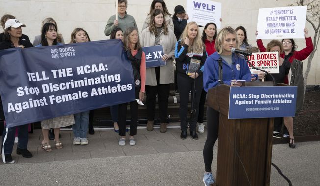 Former University of Kentucky swimmer Riley Gaines, right, speaks during a rally on Thursday, Jan. 12, 2023, outside of the NCAA Convention in San Antonio. (AP Photo/Darren Abate)
