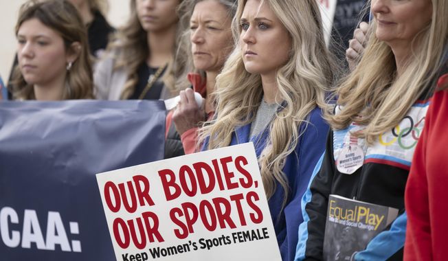Former University of Kentucky swimmer Riley Gaines, second from right, stands during a rally on Thursday, Jan. 12, 2023, outside of the NCAA Convention in San Antonio. (AP Photo/Darren Abate **FILE**