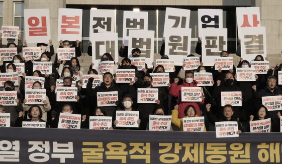 Members of a civic group seeking compensation from Japanese firms over forced labor during World War II and opposition lawmakers stage a rally to oppose the government&#x27;s reported resolution to the issue outside the National Assembly in Seoul, Thursday, Jan. 12, 2023. The banners read &quot;Apology and compensation from Japanese war criminal companies and condemn the government of President Yoon Suk Yeol.&quot; (AP Photo/Ahn Young-joon)
