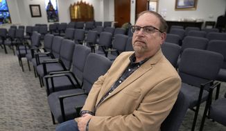 In this Dec. 22, 2022, photo, Jeff Cohen poses for a photo in the area of Congregation Beth Israel where he was sitting when taken hostage in Colleyville, Texas. Healing from the Jan. 15, 2022, ordeal is ongoing. (AP Photo/Tony Gutierrez) ** FILE **