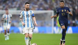 Argentina&#x27;s Lionel Messi goes for the ball next to France&#x27;s Kylian Mbappe during the World Cup final soccer match between Argentina and France at the Lusail Stadium in Lusail, Qatar, Sunday, Dec.18, 2022. (AP Photo/Manu Fernandez)