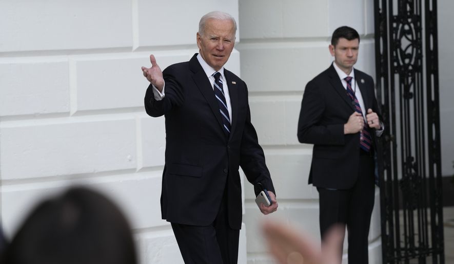 Reporters try to get the attention of President Joe Biden as walks out of the White House in Washington and heads towards Marine One on the South Lawn, Friday, Jan. 13, 2023. Biden is heading to Delaware for the weekend. (AP Photo/Susan Walsh)