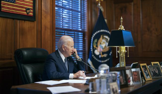 In this file image provided by The White House, President Joe Biden speaks with Russian President Vladimir Putin on the phone from his private residence in Wilmington, Del., Dec. 30, 2021. Biden acknowledged on Thursday that a document with classified markings from his time as vice president was found in his “personal library” at his home in Wilmington, Delaware, along with other documents found in his garage, days after it was disclosed that sensitive documents were also found at the office of his former institute in Washington. (Adam Schultz/The White House via AP, File)