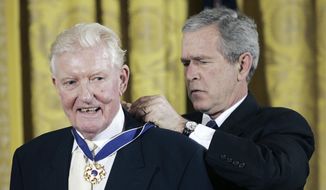 Historian and journalist Paul Johnson, left, receives the Presidential Medal of Freedom from United States President Bush during a ceremony in the East Room of the White House in Washington, Friday, Dec. 15, 2006. British author, historian and journalist Paul Johnson, who shifted his allegiances from the left to support Margaret Thatcher and Conservative causes, died Thursday, Jan. 13, 2023, after a long illness, his son announced on social media. He was 94. (AP Photo/Pablo Martinez Monsivais, File)