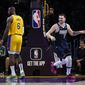 Dallas Mavericks&#39; Luka Doncic (77) smiles after making a basket against Los Angeles Lakers&#39; LeBron James (6) during the first half of an NBA basketball game Thursday, Jan. 12, 2023, in Los Angeles. (AP Photo/Jae C. Hong)